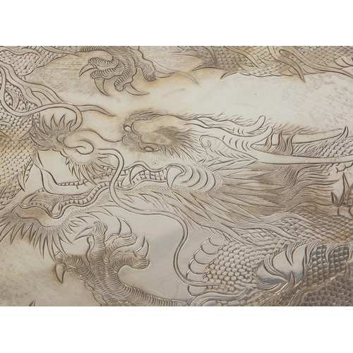 796 - Chinese silver salver by Wang Hing engraved with dragons, the pierced border decorated with dragons ... 