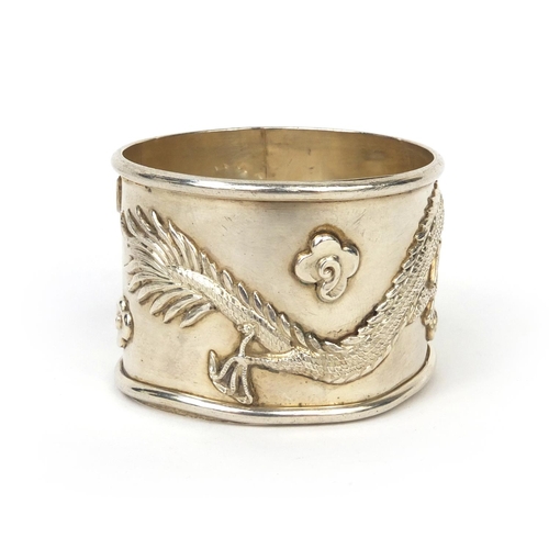 800 - Chinese silver napkin ring decorated in relief with a dragon amongst clouds, character marks to the ... 