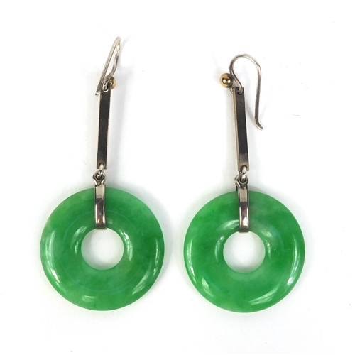 803 - Pair of Chinese green jade hoop earrings with white metal mounts, each 2.8cm in diameter excluding t... 