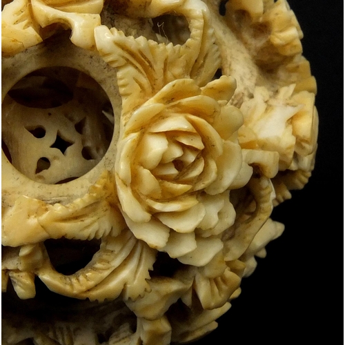 793 - Chinese Cantonese ivory layered puzzle ball carved with flowers, 5.5cm in diameter