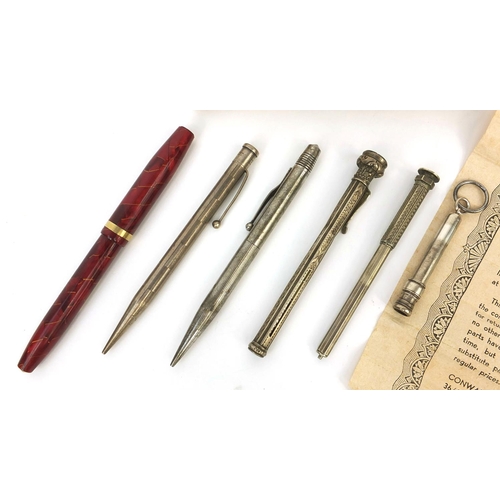 324 - Group of propelling pencils together with a boxed Conway Stewart red marbleised fountain pen with 14... 