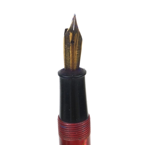 324 - Group of propelling pencils together with a boxed Conway Stewart red marbleised fountain pen with 14... 