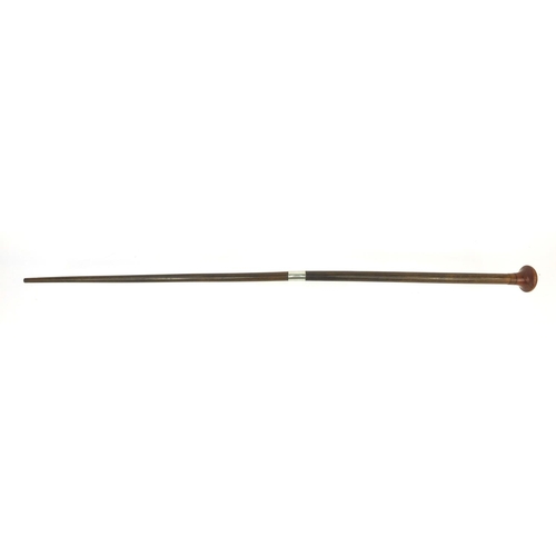 786 - Chinese rhino horn walking stick with silver coloured metal band and wooden pommel, 86.5cm long, app... 