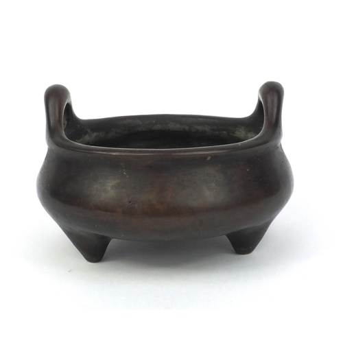 826 - Chinese bronze three footed censor twin handles, character marks to the base, 17cm in diameter, appr... 