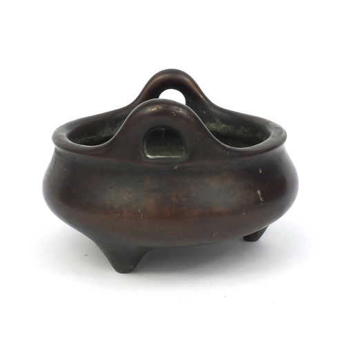 826 - Chinese bronze three footed censor twin handles, character marks to the base, 17cm in diameter, appr... 