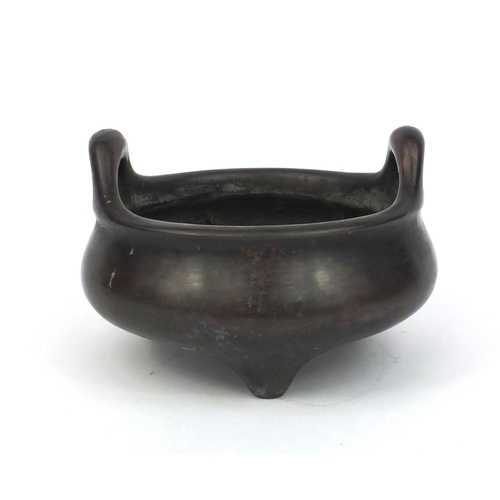 826 - Chinese bronze three footed censor twin handles, character marks to the base, 17cm in diameter, appr... 