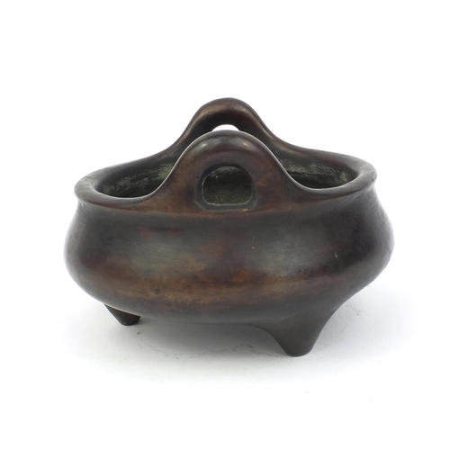 826 - Chinese bronze three footed censor twin handles, character marks to the base, 17cm in diameter, appr... 