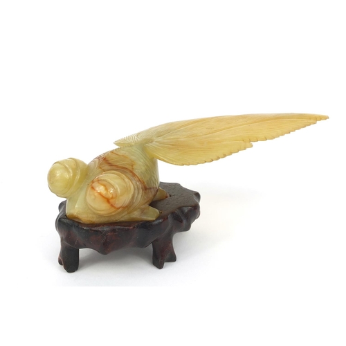 824 - Chinese jade goldfish raised on a hardwood base, 16cm long