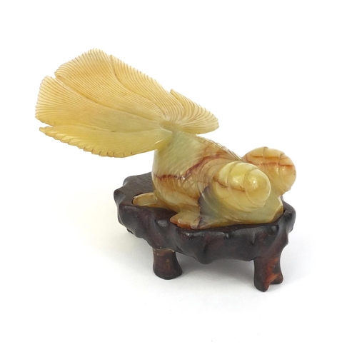 824 - Chinese jade goldfish raised on a hardwood base, 16cm long