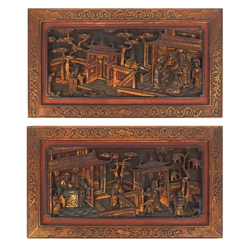 814 - Pair of Chinese wooden panels carved with figures in a palace setting, each 28cm high x 50cm wide