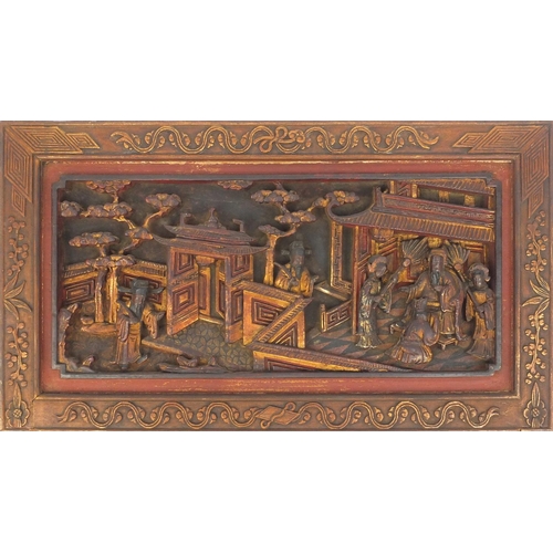 814 - Pair of Chinese wooden panels carved with figures in a palace setting, each 28cm high x 50cm wide