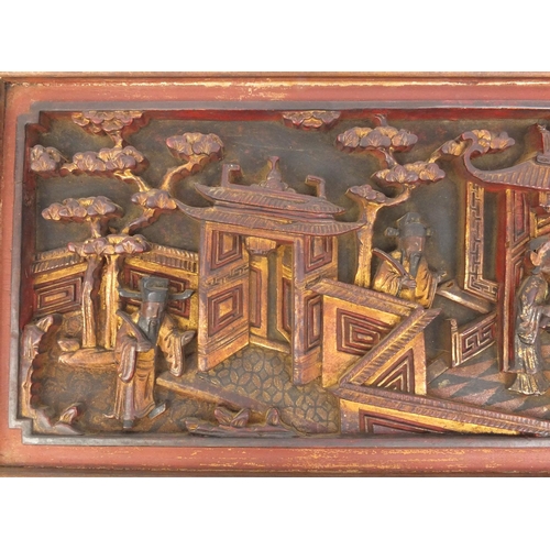 814 - Pair of Chinese wooden panels carved with figures in a palace setting, each 28cm high x 50cm wide