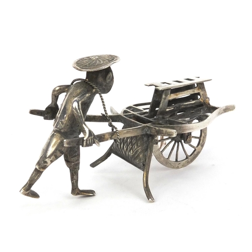 801 - Chinese silver model of a street vendor, character marks to the wheel, 8cm long, approximate weight ... 