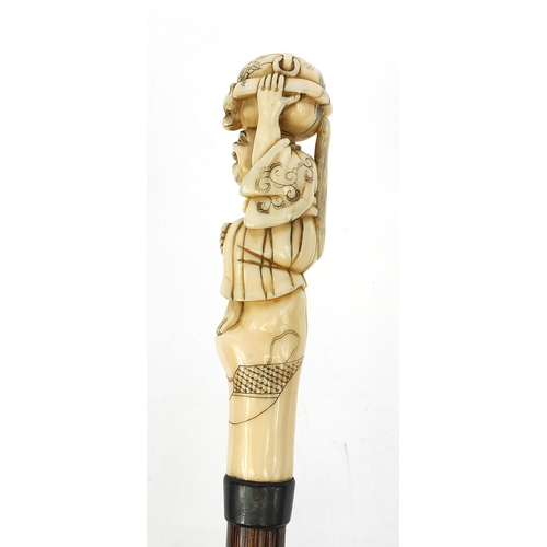 787 - Victorian silk parasol with Japanese carved ivory top in the form of a gentleman holding a twin hand... 