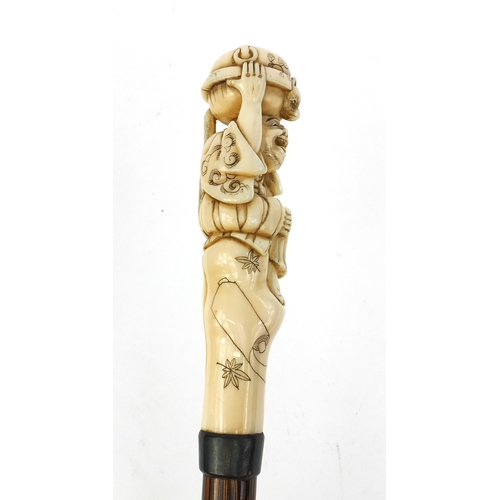 787 - Victorian silk parasol with Japanese carved ivory top in the form of a gentleman holding a twin hand... 