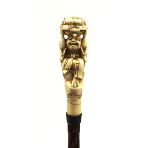 787 - Victorian silk parasol with Japanese carved ivory top in the form of a gentleman holding a twin hand... 