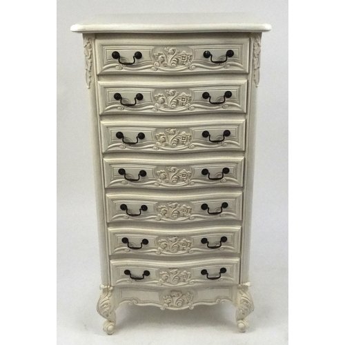 2028 - Cream serpentine fronted seven drawer chest with carved decoration , 126cm high