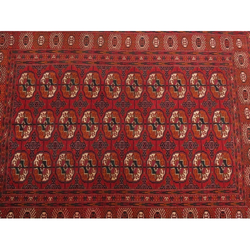 2025a - Rectangular Turkoman Bokara rug, the central field and boarder decorated Tribal gul motifs onto a re... 