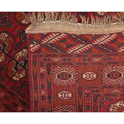 2025a - Rectangular Turkoman Bokara rug, the central field and boarder decorated Tribal gul motifs onto a re... 