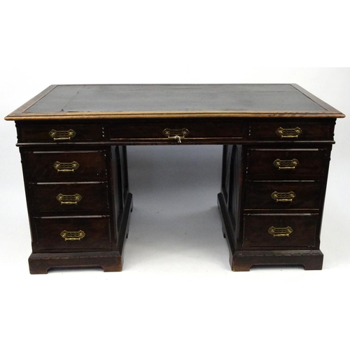 2 - Arts & Crafts twin pedestal desk fitted with an arrangement of nine drawers, 97cm high x 141cm wide ... 