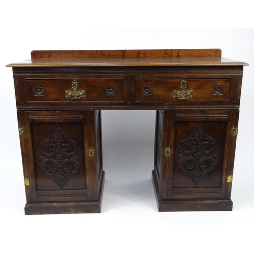58 - Carved oak twin pedestal side board with two drawers, 89cm high x 121cm wide x 45cm deep