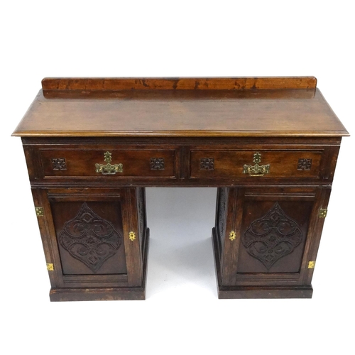 58 - Carved oak twin pedestal side board with two drawers, 89cm high x 121cm wide x 45cm deep