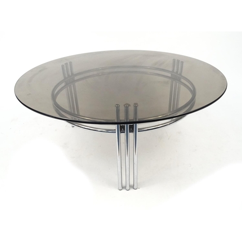 37 - Circular polished metal coffee table with smoky glass top, 42cm high x 100cm in diameter