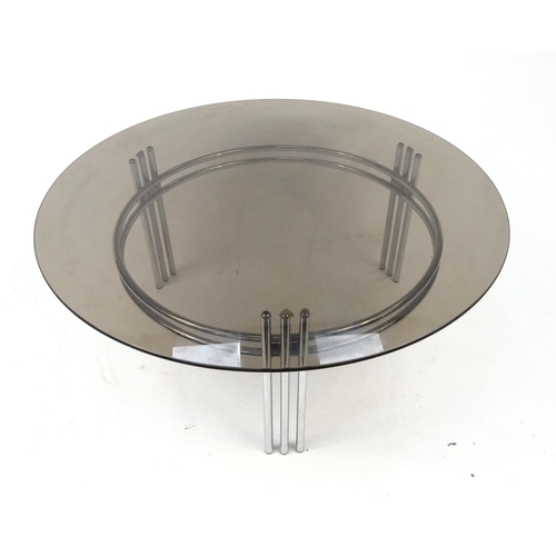 37 - Circular polished metal coffee table with smoky glass top, 42cm high x 100cm in diameter