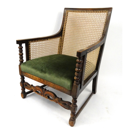 21 - Oak framed bergere chair with green upholstered seat, 91cm high