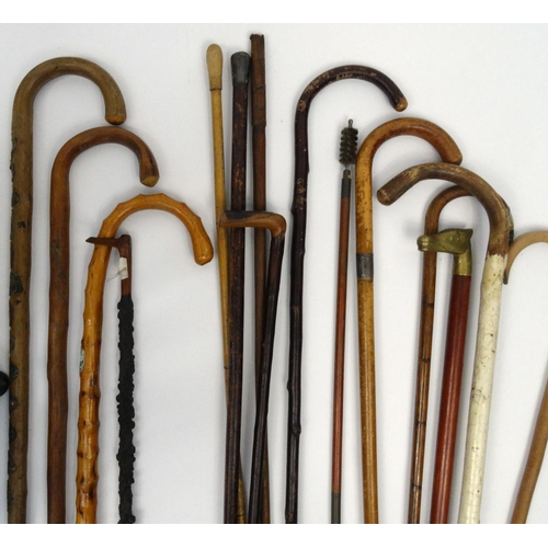 28 - Collection of wooden walking sticks including one with a silver handle, some with animal head handle... 