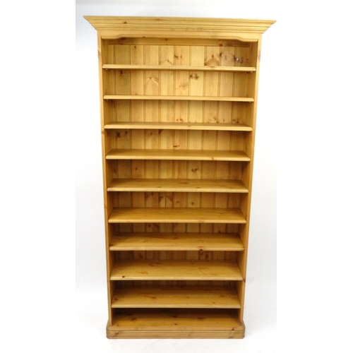 27 - Pine bookcase fitted with nine adjustable shelves, 188cm high x 96cm wide x 25cm deep