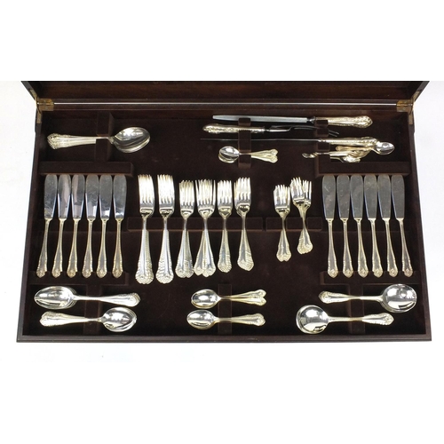 2003 - Twelve place canteen of Sheffield silver plated cutlery including fish servers contained in a mahoga... 