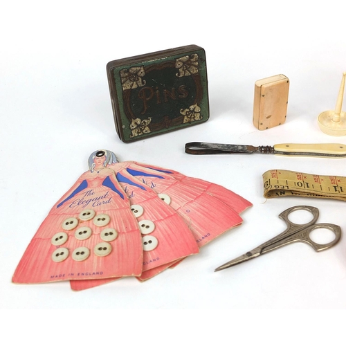 72 - Group of sewing related objects including an ivory vesta case, set of book shaped containers, button... 