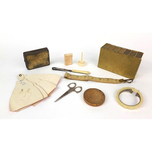 72 - Group of sewing related objects including an ivory vesta case, set of book shaped containers, button... 