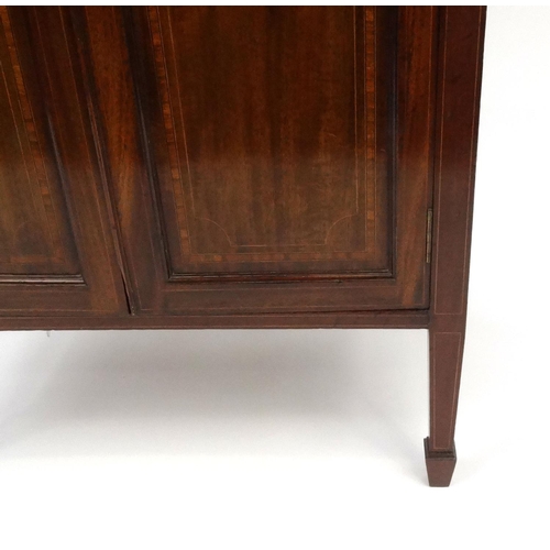 2038 - Edwardian inlaid mahogany two door cupboard raised on tapering legs with spade feet, 96cm high x 67c... 