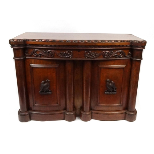 2028 - Carved Victorian sideboard fitted with two bow fronted doors, each with applied carved bird motifs, ... 