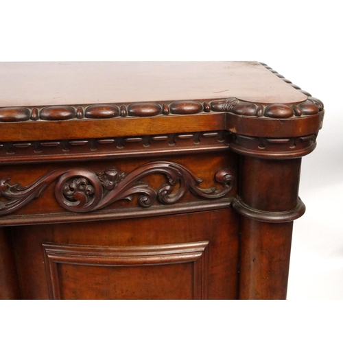 2028 - Carved Victorian sideboard fitted with two bow fronted doors, each with applied carved bird motifs, ... 