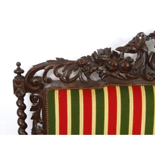 2014 - Oak hall bench with striped upholstery, the back profusely carved with Phoenixes and foliage, the ar... 