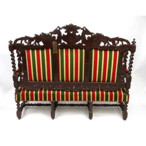 2014 - Oak hall bench with striped upholstery, the back profusely carved with Phoenixes and foliage, the ar... 
