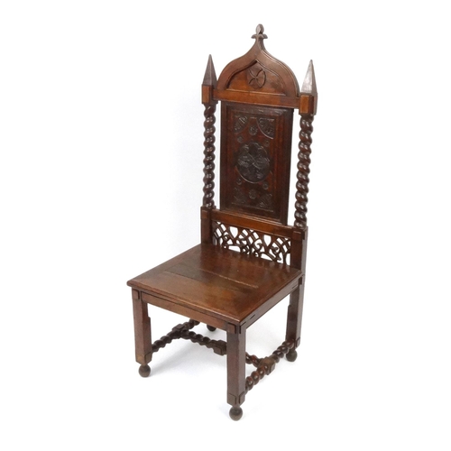 2022 - Gothic design oak hall chair with carved panel back and barley twist supports, 145cm high