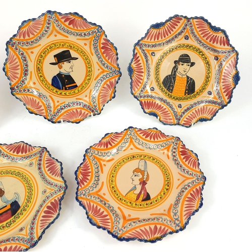 2318 - Group of five Quimper pottery plates, each hand painted with Traditional figures, each 25cm in diame... 