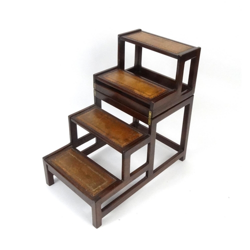 2008 - Set of Metamorphic mahogany library steps converting to a coffee table with tooled leather top, the ... 
