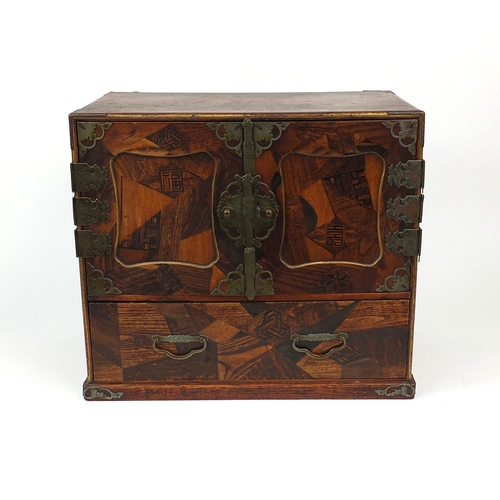 2044 - Table top parquetry cabinet fitted with two cupboard doors opening to reveal an arrangement of drawe... 