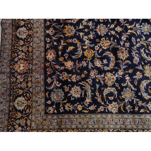 2013 - Large rectangular Persian Kashan rug, the central field and boarders with a stylised floral design o... 