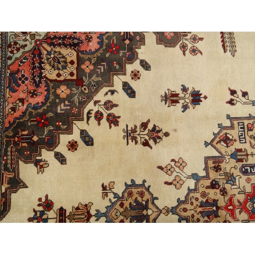 2041 - Rectangular Middle Eastern Tabriz rug, the central field and boarders with a stylised floral design,... 