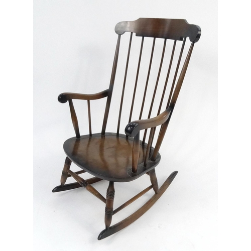 124 - Stained wooden stick back rocking chair