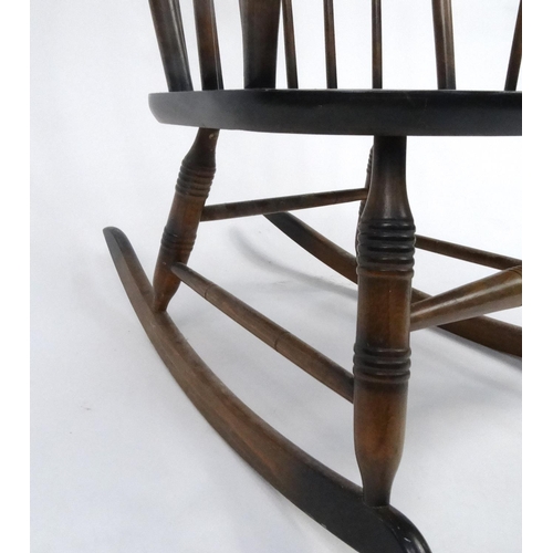 124 - Stained wooden stick back rocking chair