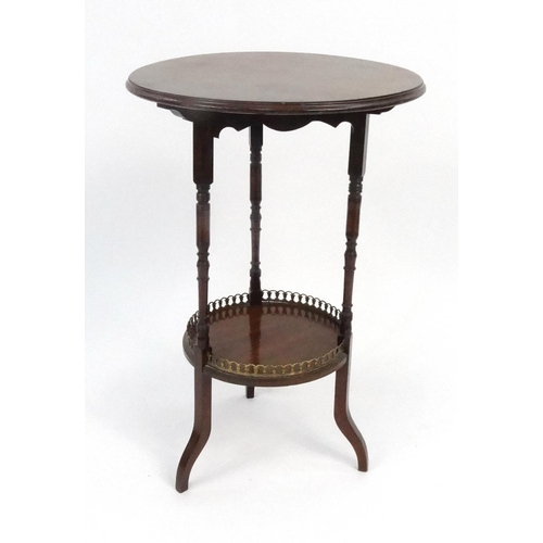 122 - Edwardian circular mahogany occasional table with brass galleried under tier, 70cm high