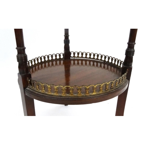 122 - Edwardian circular mahogany occasional table with brass galleried under tier, 70cm high