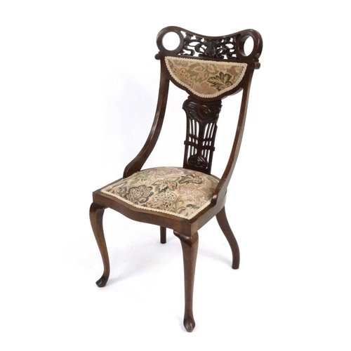 112 - Art Nouveau influence carved mahogany occasional chair, the back 96cm high